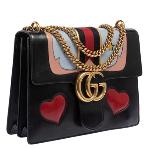 black Gucci purse with heart